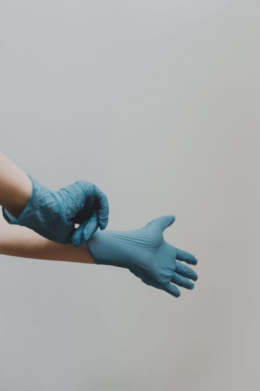 Image of a Connecticut maxillofacial surgeon pulling on blue nitrile gloves